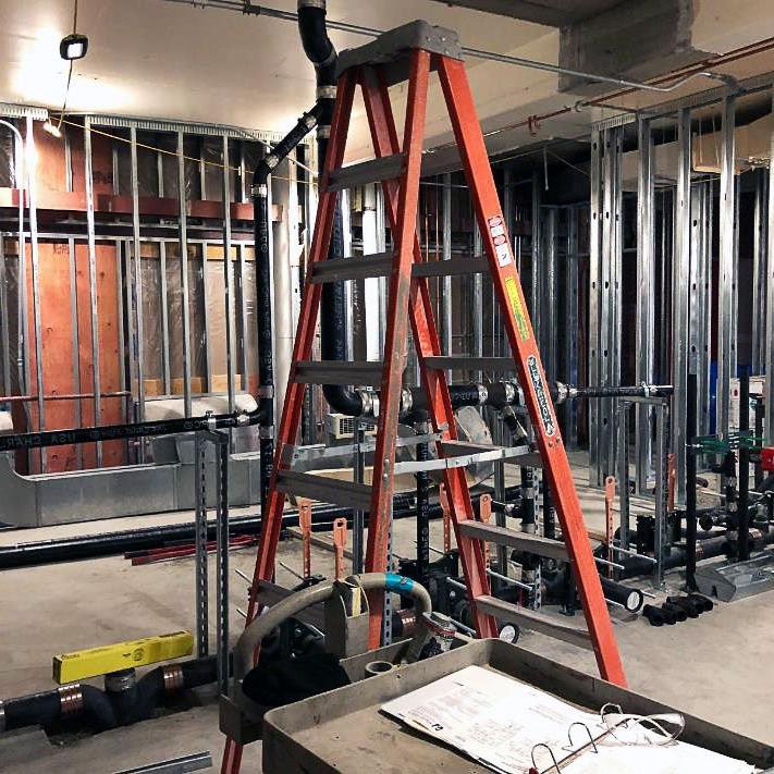 a room under construction with metal framing and a ladder