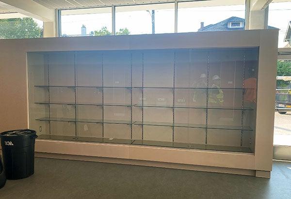 an empty trophy case with windows behind it