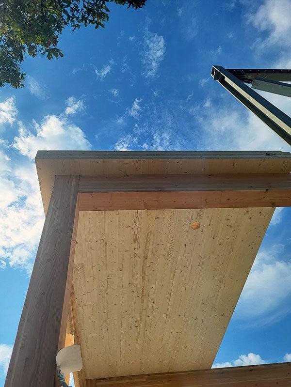 a cross-laminated timber panel rests on glulam wood framing