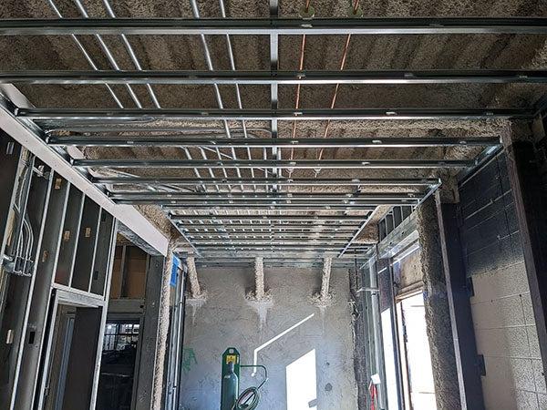 meal wall and ceiling framing with wood above the ceiling framing