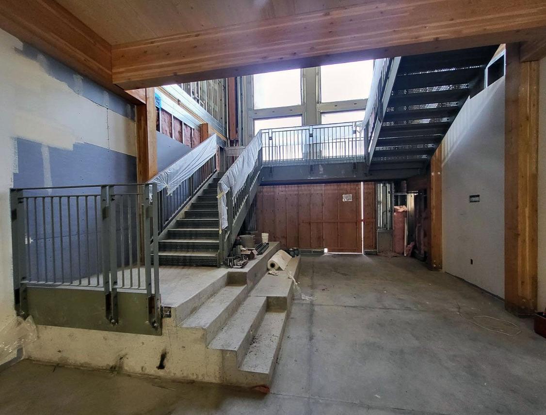 a stairway wraps up two levels to the next floor