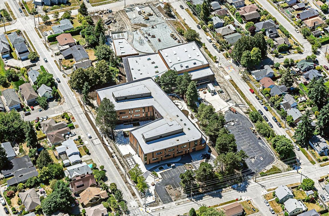 aerial view of two large buildings and a parking lot