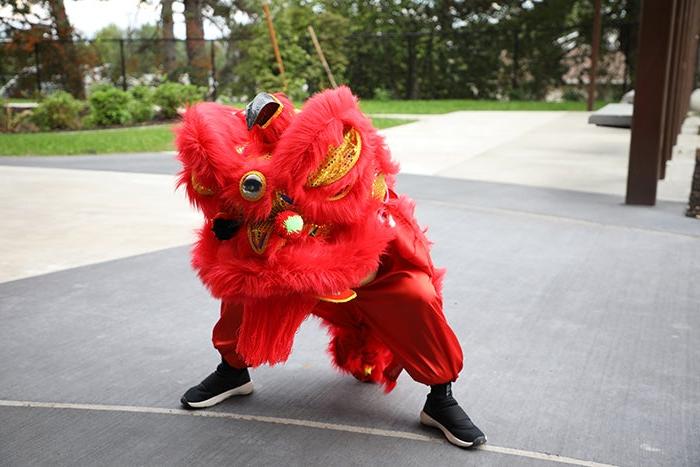 a person in a red lion dancer costume