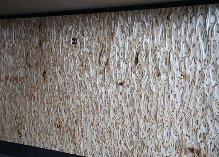 a wood wall has texture carved into it